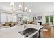Close-up of the kitchen island featuring a stainless steel sink, countertop, and modern faucet at 308 Furches St, Raleigh, NC 27607