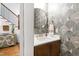 Stylish powder room featuring unique wallpaper, elegant mirror, and modern fixtures at 308 Furches St, Raleigh, NC 27607