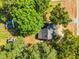 Roof top view of a traditional home surrounded by tall trees and greenery, creating a private outdoor space at 310 Chicopee Rd, Benson, NC 27504