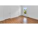 Bright bedroom with laminate floors, neutral paint, and bright windows at 310 Chicopee Rd, Benson, NC 27504
