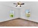 Bright bedroom with neutral carpet, fan and light fixture, and dual windows at 310 Chicopee Rd, Benson, NC 27504
