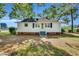 Exterior shot of house with grass and gravel yard at 310 Chicopee Rd, Benson, NC 27504