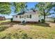 Charming single-story home with a tidy front yard and classic architectural details and design elements at 310 Chicopee Rd, Benson, NC 27504