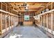Spacious garage with exposed wooden beams and a small window at the back at 310 Chicopee Rd, Benson, NC 27504