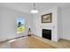 Cozy living room featuring a decorative fireplace and a large window at 310 Chicopee Rd, Benson, NC 27504