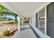 Long porch with white pillars, gray floor and railing and view of the front yard at 310 Chicopee Rd, Benson, NC 27504