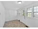 Sunroom features lots of natural light and neutral tile flooring at 310 Chicopee Rd, Benson, NC 27504