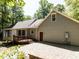 Rear exterior showcasing a well-maintained yard and stone patio, blending indoor and outdoor living at 312 Heidinger Dr, Cary, NC 27511