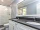 Modern bathroom with double vanity, gray countertops, and glass-enclosed shower at 312 Heidinger Dr, Cary, NC 27511
