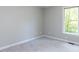 Carpeted bedroom featuring a window for natural light and neutral walls at 312 Heidinger Dr, Cary, NC 27511