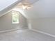 Image of a finished attic bedroom with a window and white trim at 312 Heidinger Dr, Cary, NC 27511