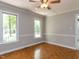 Neutral bedroom showcasing two windows and hardwood floors at 312 Heidinger Dr, Cary, NC 27511