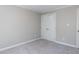 Carpeted bedroom with base trim, neutral colored walls and a closet with double doors at 312 Heidinger Dr, Cary, NC 27511