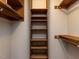 Walk-in closet with built-in wooden shelving and ample storage space at 312 Heidinger Dr, Cary, NC 27511