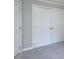 Image shows double doors to a closet with 6 panels on each side and neutral colored walls at 312 Heidinger Dr, Cary, NC 27511