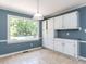 Bright dining area featuring a large window and white cabinetry with a light fixture at 312 Heidinger Dr, Cary, NC 27511