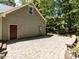 Side view of home exterior with stone patio and lush landscape surrounding the area at 312 Heidinger Dr, Cary, NC 27511