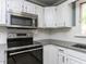 Close-up of the modern kitchen with stainless steel appliances, and white cabinets at 312 Heidinger Dr, Cary, NC 27511