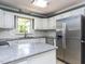 Kitchen featuring stainless steel appliances, light countertops, and plenty of cabinet storage at 312 Heidinger Dr, Cary, NC 27511