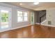 Open living room features hardwood floors, natural light, and access to the sunroom at 312 Heidinger Dr, Cary, NC 27511