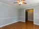 Living room with ceiling fan, hardwood floors, and large doorway at 312 Heidinger Dr, Cary, NC 27511