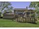 Exterior backyard view featuring a deck, patio, and lush green lawn, perfect for outdoor enjoyment at 3204 Peachford Ln, Raleigh, NC 27616