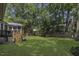 Expansive backyard with lush lawn and mature trees, perfect for outdoor activities and relaxation at 3204 Peachford Ln, Raleigh, NC 27616