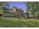 Back of house featuring a large yard, screened patio, deck, and a blue umbrella at 3204 Peachford Ln, Raleigh, NC 27616