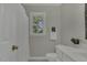 Bright bathroom with a window, a decorative mirror and a white vanity sink at 3204 Peachford Ln, Raleigh, NC 27616