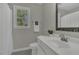 Bathroom with white vanity, framed mirror, shower curtain and window with natural light at 3204 Peachford Ln, Raleigh, NC 27616
