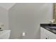 Powder room featuring a white sink cabinet with dark countertop and minimal decoration at 3204 Peachford Ln, Raleigh, NC 27616
