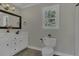 Bathroom with double sink vanity, framed mirror, and natural light from the window at 3204 Peachford Ln, Raleigh, NC 27616