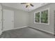 Bright bedroom featuring a ceiling fan and a double window bringing in natural light at 3204 Peachford Ln, Raleigh, NC 27616
