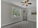 Bedroom features a ceiling fan, a bright window and grey carpeting at 3204 Peachford Ln, Raleigh, NC 27616