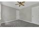 Bedroom with neutral walls, gray carpeting, a window, and two doors at 3204 Peachford Ln, Raleigh, NC 27616