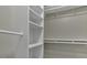 Walk-in closet featuring white shelves and metal rods at 3204 Peachford Ln, Raleigh, NC 27616