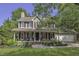 Charming traditional home with mature trees and a well-manicured front lawn at 3204 Peachford Ln, Raleigh, NC 27616