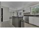 Open concept kitchen features white cabinets, an island and stainless steel appliances at 3204 Peachford Ln, Raleigh, NC 27616
