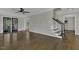 Open-concept living room with hardwood floors and staircase access at 3204 Peachford Ln, Raleigh, NC 27616