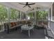 Screened-in porch with cozy seating and natural light, perfect for relaxing outdoors at 3204 Peachford Ln, Raleigh, NC 27616