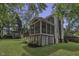 Backyard view of a screened in porch perfect for outdoor living and entertaining with lots of privacy at 3204 Peachford Ln, Raleigh, NC 27616