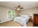 A bright bedroom with a large window, allowing natural light to illuminate the cozy space at 3301 Manor Ridge Dr, Raleigh, NC 27603