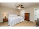 Bedroom with a double bed, side tables, and dresser, illuminated by natural light and ceiling fan at 3301 Manor Ridge Dr, Raleigh, NC 27603