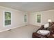 Bedroom with neutral carpet, ample natural light, and a comfortable leather sofa at 3301 Manor Ridge Dr, Raleigh, NC 27603