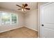 A well lit, neutral bedroom features a large window and ceiling fan, creating a comfortable living space at 3301 Manor Ridge Dr, Raleigh, NC 27603