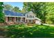 Charming brick and siding home featuring a well-manicured lawn and inviting curb appeal on a sunny day at 3301 Manor Ridge Dr, Raleigh, NC 27603