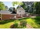 Beautiful brick and siding exterior with a well-maintained lawn, mature trees, and a cozy backyard setting at 3301 Manor Ridge Dr, Raleigh, NC 27603