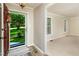 Inviting foyer with wood-look flooring, neutral paint, and a view of the beautifully landscaped front yard through the front door at 3301 Manor Ridge Dr, Raleigh, NC 27603