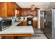 Traditional kitchen with wood cabinets and stainless steel appliances for modern convenience at 3301 Manor Ridge Dr, Raleigh, NC 27603