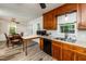 Kitchen with wood cabinets, a breakfast bar, and adjacent dining area for convenient living at 3301 Manor Ridge Dr, Raleigh, NC 27603